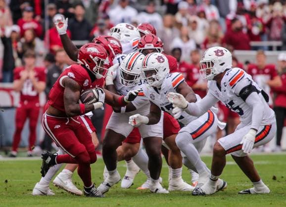 October 25, 2025, Fayetteville, Arkansas, USA: Arkansas Razorbacks running back MIKE WASHINGTON JR. (4) rushes and is met by Auburn Tiger linebacker XAVIER ATKINS (17) and defensive end KELDRIC FAULK (15) during Auburn s win over Arkansas at Donald W. Reynolds Razorback Stadium. Fayetteville USA - ZUMAs199 20251025_znp_s199_002 Copyright: xBrentxSoulex