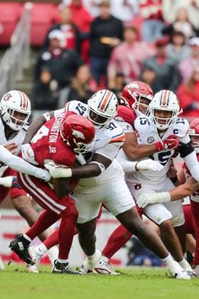 October 25, 2025: Auburn defensive lineman Bobby Jamison-Travis (97) wraps up Razorback running Mike Washington Jr. (4) behind the line. Auburn defeated Arkansas 33-24 in Fayetteville, AR. CSM Fayetteville USA - ZUMAcm9_ 20251025_faf_cm9_091 Copyright: xRicheyxMillerx