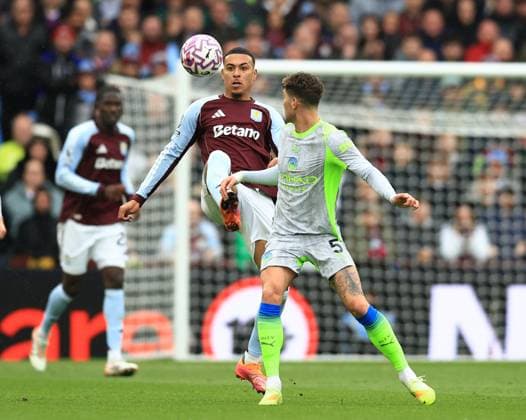 Birmingham, England, 26th October 2025. Morgan Rogers of Aston Villa tussles with John Stones of Manchester City during the Aston Villa vs Manchester City Premier League match at Villa Park, Birmingham. Picture credit should read: Jessica Hornby Sportimage EDITORIAL USE ONLY. No use with unauthorised audio, video, data, fixture lists, club league logos or live services. Online in-match use limited to 120 images, no video emulation. No use in betting, games or single club league player publications. SPI_022_JH_Villa_City SPI-4240-0022