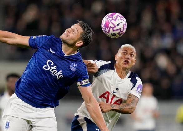 Liverpool, England, 26th October 2025. James Tarkowski of Everton tussles with Richarlison of Tottenham during the Everton vs Tottenham Hotspur Premier League match at Hill Dickinson Stadium, Liverpool. Picture credit should read: Andrew Yates Sportimage EDITORIAL USE ONLY. No use with unauthorised audio, video, data, fixture lists, club league logos or live services. Online in-match use limited to 120 images, no video emulation. No use in betting, games or single club league player publications. SPI_050_AY_Everton_Spurs SPI-4241-0050