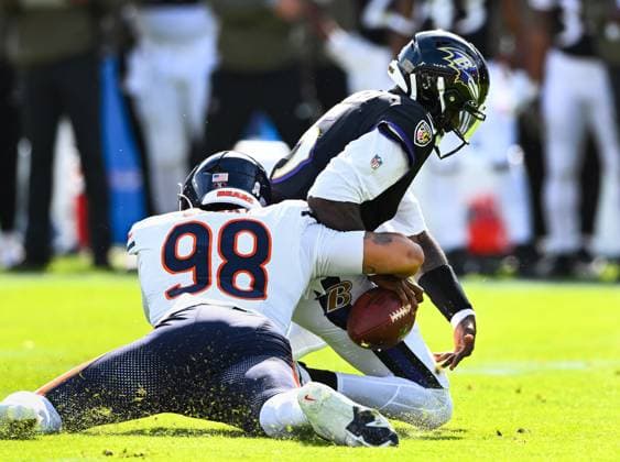 Chicago Bears defensive lineman Montez Sweat (98) sacks Baltimore Ravens quarterback Tyler Huntley (5) during the first quarter at M&T Bank Stadium in Baltimore, Maryland, on Sunday, October 26, 2025.  BAL20251026113 DAVIDxTULIS