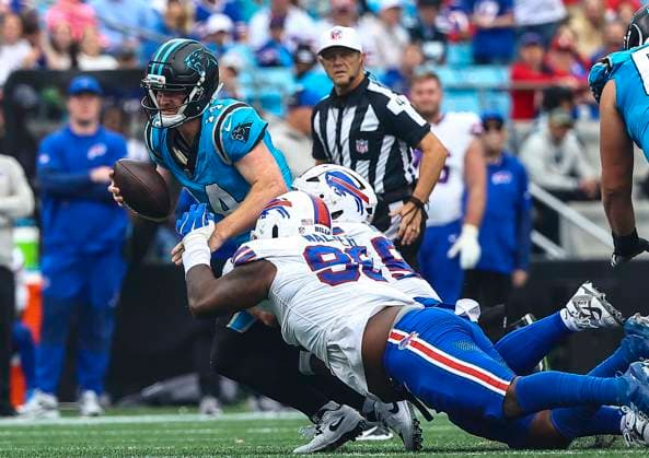 October 26, 2025: Carolina quarterback Andy Dalton (14) gets sacked by Buffalo defensive tackle Deone Walker (96) NFL, American Football Herren, USA football game between Buffalo Bills and Carolina Panthers at Bank of America Stadium, Charlotte , North Carolina. CSM Charlotte United States of America - ZUMAc04_ 20251026_zma_c04_084 Copyright: xDavidxBeachx