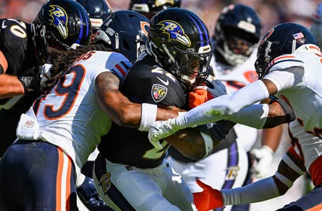 Baltimore Ravens running back Derrick Henry (22) is stopped by a pack of Chicago Bears after a short gain during the second quarter at M&T Bank Stadium in Baltimore, Maryland, on Sunday, October 26, 2025. Baltimore won 30-16 to break a four game losing streak.  BAL20251026137 DAVIDxTULIS