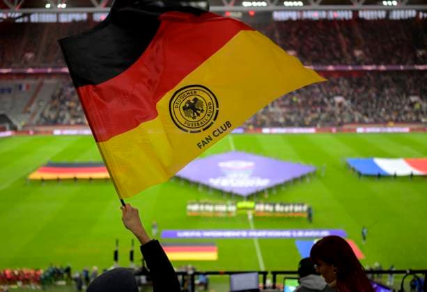 Feature, ger supporters swings a Flag, DFB supporter Club, The both Teams during the Anthem, Overview, Flag, Football UEFA Women s Nations League, Semi-finals First leg, Germany ger France FRA 1 0, at 24 10 2025 in Dusseldorf Germany Mercury Game Arena