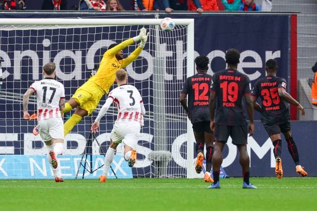 (251027) -- LEVERKUSEN, Oct. 27, 2025 -- Goalkeeper of SC Freiburg Noah Atubolu (rear) makes a save during the first division of Bundesliga football match between Bayer 04 Leverkusen and SC Freiburg in Leverkusen, Germany, Oct. 26. 2025. (Photo by Xinhua) (SP)GERMANY-LEVERKUSEN-FOOTBALL-BUNDESLIGA-LEVERKUSEN VS FREIBURG JoachimxBywaletz 