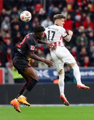 (251027) -- LEVERKUSEN, Oct. 27, 2025 -- Edmond Tapsoba (L) of Bayer 04 Leverkusen and Lukas Kubler of SC Freiburg head for the ball during the first division of Bundesliga football match between Bayer 04 Leverkusen and SC Freiburg in Leverkusen, Germany, Oct. 26. 2025. (Photo by Xinhua) (SP)GERMANY-LEVERKUSEN-FOOTBALL-BUNDESLIGA-LEVERKUSEN VS FREIBURG JoachimxBywaletz 