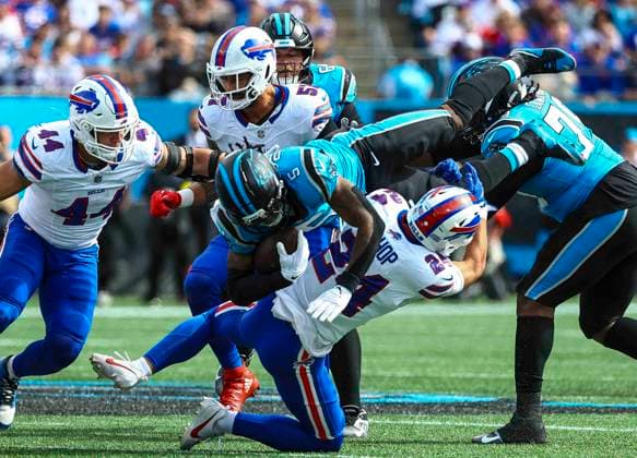 October 26, 2025: Carolina running back Rico Dowdle (5) goes over the tackle of Buffalo saftey Cole Bishop (24). NFL, American Football Herren, USA football game between Buffalo Bills and Carolina Panthers at Bank of America Stadium, Charlotte , North Carolina. CSM Charlotte United States of America - ZUMAc04_ 20251026_zma_c04_256 Copyright: xDavidxBeachx