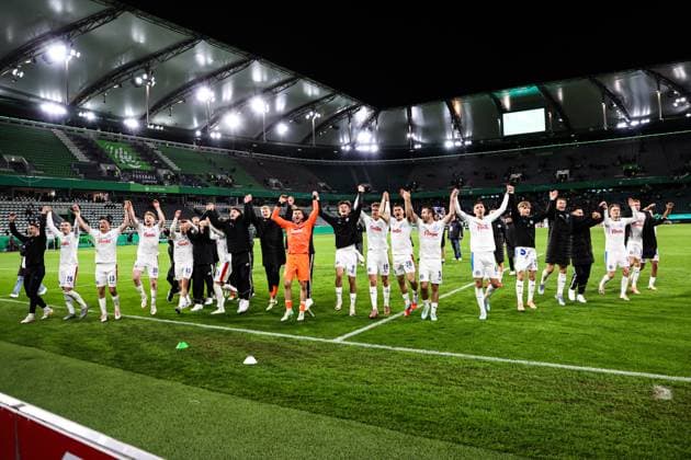The Holstein Kiel team celebrates the victory in front of the fan block 2 round DFB Cup season 2025 2026 VfL Wolfsburg vs Holstein Kiel at the Volkswagen Arena in Wolfsburg Action,Football,Germany,Man,Men,28 10 2025