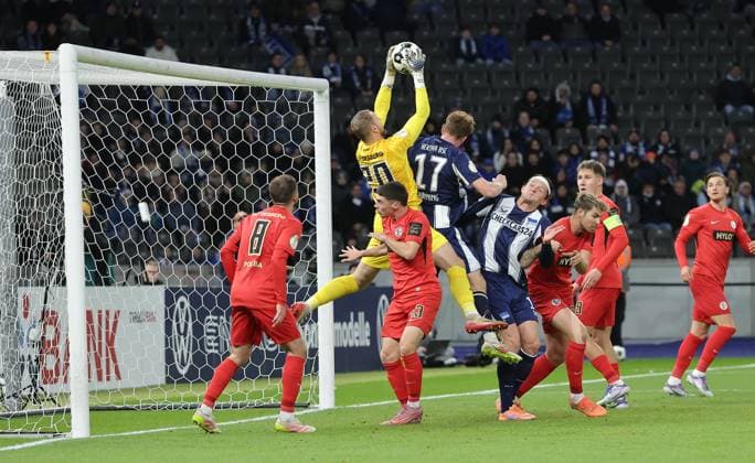 Goalkeeper Nicolas Kristof catches the ball, Sebastian Grönning duel Match scene Action Sport Soccer Football DFB Pokal 2 Round Men Season 2025 2026 28 10 2025 Hertha BSC Berlin vs SV Elversberg DFL regulations prohibit any use of photographs as image sequences and or quasi video