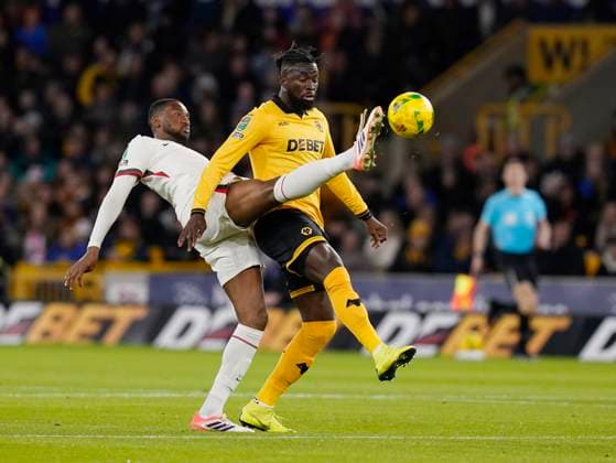 Wolverhampton, England, 29th October 2025. Tosin Adarabioyo of Chelsea tackles Santiago Bueno of Wolverhampton Wanderers during the Wolverhampton Wanderers vs Chelsea Carabao Cup match at Molineux, Wolverhampton. Picture credit should read: Andrew Yates Sportimage EDITORIAL USE ONLY. No use with unauthorised audio, video, data, fixture lists, club league logos or live services. Online in-match use limited to 120 images, no video emulation. No use in betting, games or single club league player publications. SPI_007_AY_Wolves_Chelsea SPI-4247-0007