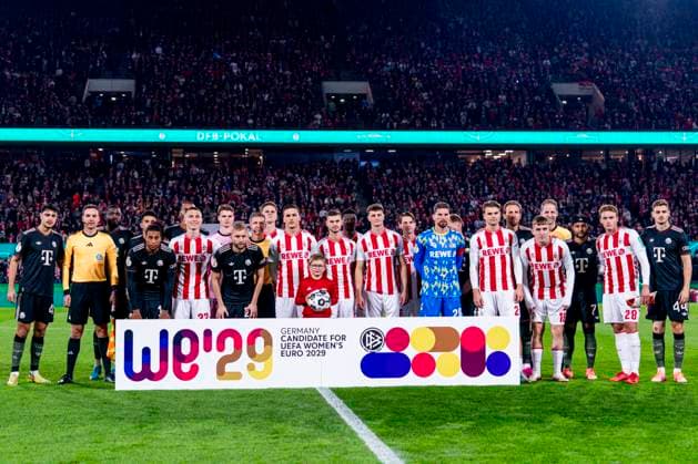COLOGNE, GERMANY - OCTOBER 29: players of of 1.FC Koln and Bayern Munchen standing behind germany candidate for women s euro 2029 banner during the DFB Cup match between 1. FC Koln and FC Bayern Munchen at RheinEnergieStadion on October 29, 2025 in Cologne, Germany. (Photo by Rene Nijhuis) SPO  Copyright: xRenexNijhuis