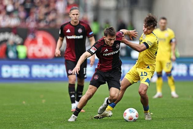 Adam Markhiyev, FCN, and Max Marie, Braunschweig, in the first round match of the 2025 2026 season between 1 FC Nuremberg and Eintracht Braunschweig 2 1 in Nuremberg 01 11 2025