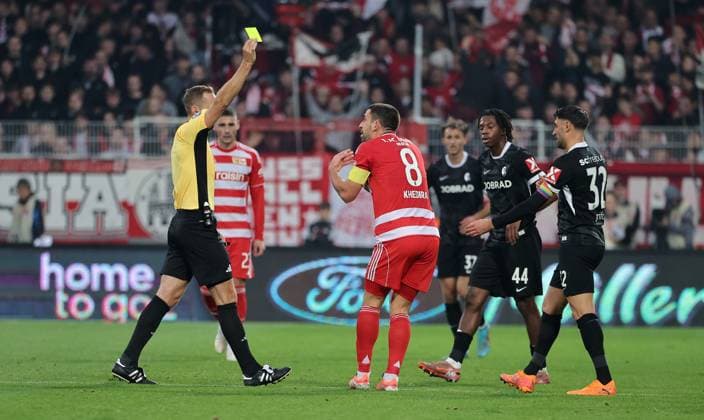 Referee Sören Storks shows yellow card for Rani Khedira Sport Football Soccer Bundesliga Men DFL 9 Matchday Season 2025 2026 01 11 2025 1 FC Union Berlin FCU vs SC Freiburg SCF DFL regulations prohibit any use of photographs as image sequences and or quasi video