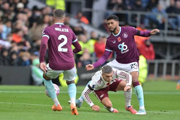 1st November 2025; Turf Moor, Burnley, Lancashire, England; Premier League Football, Burnley versus Arsenal; Josh Laurent of Burnley trips Leandro Trossard of Arsenal during a challenge  LeexDurkin