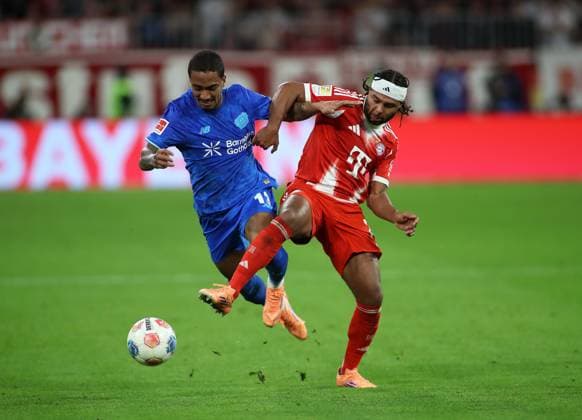 Football, Men, Bundesliga, Season 2025 2026, FC Bayern München Bayer 04 Leverkusen, Allianz Arena Arthur Bayer 04 Leverkusen left with Serge Gnabry FC Bayern München right in a duel for the ball DFB, DFL regulations prohibit any use of photographs as image sequences and or quasi video