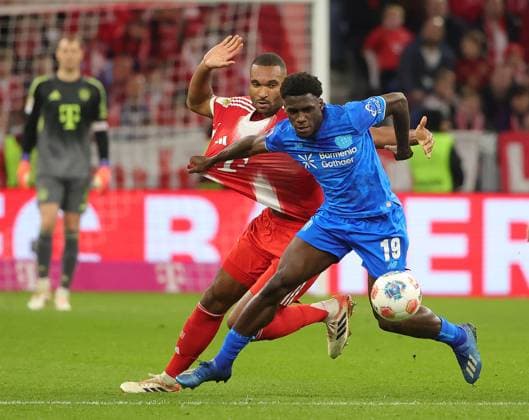 (251102) -- MUNICH, Nov. 2, 2025 -- Jonathan Tah (L) of Bayern Munich vies with Ernest Poku of Bayer 04 Leverkusen during the German first division Bundesliga football match between Bayern Munich and Bayer 04 Leverkusen in Munich, Germany, Nov. 1, 2025. (Photo by Xinhua) (SP)GERMANY-MUNICH-FOOTBALL-BUNDESLIGA-BAYERN MUNICH VS LEVERKUSEN PhilippexRuiz 