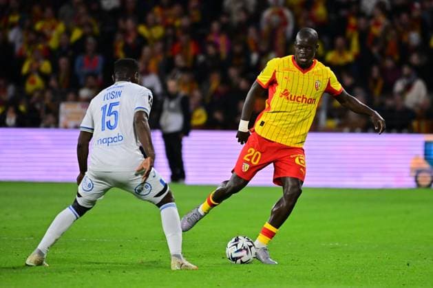 FOOTBALL : Lens vs Lorient - Ligue 1 - 02 11 2025 Malang Sarr ( 20 - Lens ) and Aiyegun Tosin ( 15 - FC Lorient ) during the Ligue 1 match between RC Lens and FC Lorient at Stade Felix Bollaert on November 02, 2025 in Lens, France. ( Photo by federico pestellini psnewz ) - LensFrance  Copyright: xFedericoxPestellinix