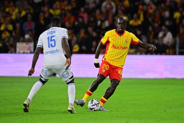 FOOTBALL : Lens vs Lorient - Ligue 1 - 02 11 2025 Malang Sarr ( 20 - Lens ) and Aiyegun Tosin ( 15 - FC Lorient ) during the Ligue 1 match between RC Lens and FC Lorient at Stade Felix Bollaert on November 02, 2025 in Lens, France. ( Photo by federico pestellini psnewz ) - LensFrance  Copyright: xFedericoxPestellinix