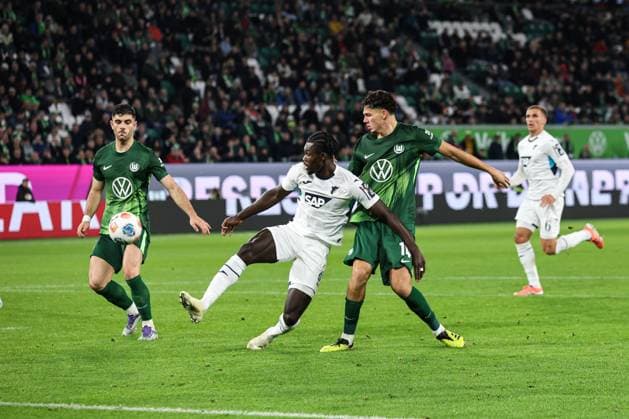Ihlas Bebou TSG Hoffenheim,9 vs Jenson Seelt r ,VfL Wolfsburg,14 and Konstantinos Koulierakis VfL Wolfsburg,4 1 Soccer Bundesliga Season 2025 2026 VfL Wolfsburg vs TSG Hoffenheim at the Volkswagen Arena in Wolfsburg Action,Soccer,Germany,Man,Men,02 11 2025