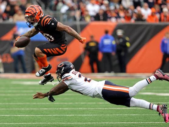 Cincinnati Bengals running back Chase Brown (30) fights to break free from Chicago Bears Nahshon Wright (26) during the second half of play at Paycor Stadium on Sunday, November 2, 2025 in Cincinnati, Ohio.  KYP20251102030 JOHNxSOMMERSxII