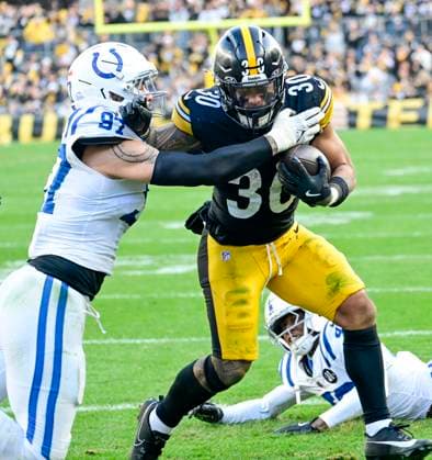 Pittsburgh Steelers running back Jaylen Warren (30) evades the tackle of Indianapolis Colts defensive end Laiatu Latu (97) and runs for the touchdown in the fourth quarter of the Steelers 27-20 win at Acrisure Stadium Sunday, November 2,2025 in Pittsburgh.  PIT2025110216 ARCHIExCARPENTER