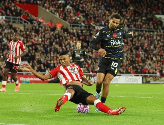 Sunderland, England, 3rd November 2025. Noah Sadiki of Sunderland blocks a shot by Iliman Ndiaye of Everton during the Sunderland vs Everton Premier League match at the Stadium Of Light, Sunderland. Picture credit should read: Nigel Roddis Sportimage EDITORIAL USE ONLY. No use with unauthorised audio, video, data, fixture lists, club league logos or live services. Online in-match use limited to 120 images, no video emulation. No use in betting, games or single club league player publications. SPI_027_NR_SUND_EVER SPI-4261-0027