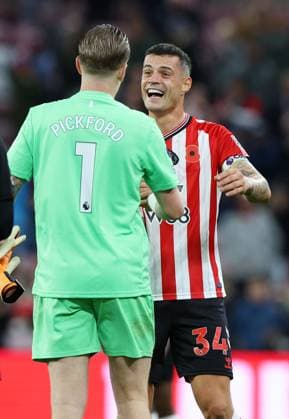 Sunderland, England, 3rd November 2025. Jordan Pickford of Everton laughs with Granit Xhaka of Sunderland at the end of the match during the Sunderland vs Everton Premier League match at the Stadium Of Light, Sunderland. Picture credit should read: Nigel Roddis Sportimage EDITORIAL USE ONLY. No use with unauthorised audio, video, data, fixture lists, club league logos or live services. Online in-match use limited to 120 images, no video emulation. No use in betting, games or single club league player publications. SPI_052_NR_SUND_EVER SPI-4261-0053