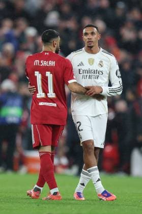 Liverpool, England, 4th November 2025. Mohamed Salah of Liverpoolhugs Trent Alexander Arnold of Real Madrid during the Liverpool vs Real Madrid UEFA Champions League match at Anfield, Liverpool. Picture credit should read: James Baylis Sportimage EDITORIAL USE ONLY. No use with unauthorised audio, video, data, fixture lists, club league logos or live services. Online in-match use limited to 120 images, no video emulation. No use in betting, games or single club league player publications. SPI_077_JB_LIVERPOOL_REAL_MADRID SPI-4264-0077