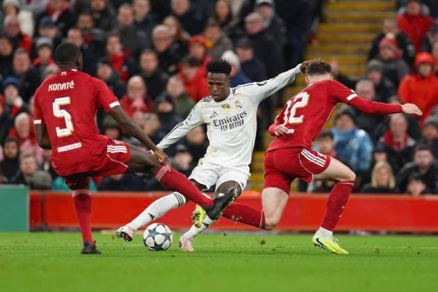 Liverpool, England, 4th November 2025. Vinicius Junior of Real Madrid and Conor Bradley of Liverpool during the Liverpool vs Real Madrid UEFA Champions League match at Anfield, Liverpool. Picture credit should read: James Baylis Sportimage EDITORIAL USE ONLY. No use with unauthorised audio, video, data, fixture lists, club league logos or live services. Online in-match use limited to 120 images, no video emulation. No use in betting, games or single club league player publications. SPI_127_JB_LIVERPOOL_REAL_MADRID SPI-4264-0126