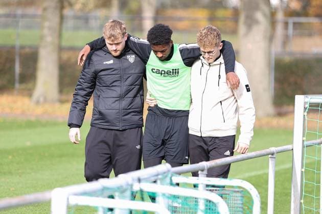 05 November 2025, Football, Training FC Schweinfurt 05, Third League, 3 League, Men Uche Obiogumu FC Schweinfurt 05, 27 leaves the field with a bruise, supported by two physios Schweinfurt Training ground Sachs Stadium Bavaria Lower Franconia Germany
