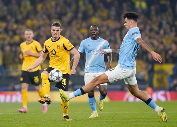 Manchester, England, 5th November 2025. Nico O™Reilly of Manchester City (r) attempts to block Marcel Sabitzer of Borussia Dortmund (l) during the Manchester City vs Borussia Dortmund UEFA Champions League match at the Etihad Stadium, Manchester. Picture credit should read: Andrew Yates Sportimage EDITORIAL USE ONLY. No use with unauthorised audio, video, data, fixture lists, club league logos or live services. Online in-match use limited to 120 images, no video emulation. No use in betting, games or single club league player publications. SPI_024_AY_Man_City_Dortmund SPI-4268-0050