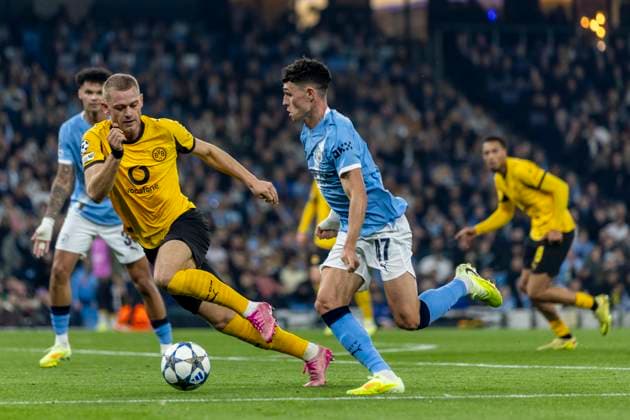 5th November 2025; Etihad Stadium, Manchester, England; UEFA Champions League Football, Manchester City versus Borussia Dortmund; Phil Foden of Manchester City under pressure from Julian Ryerson of Borussia Dortmund  TimxWilliams