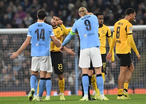 Manchester, England, 5th November 2025. Emre Can of Borussia Dortmund objects to Erling Haaland of Manchester City during the Manchester City vs Borussia Dortmund UEFA Champions League match at the Etihad Stadium, Manchester. Picture credit should read: Cody Froggatt Sportimage EDITORIAL USE ONLY. No use with unauthorised audio, video, data, fixture lists, club league logos or live services. Online in-match use limited to 120 images, no video emulation. No use in betting, games or single club league player publications. SPI_052_CF_Man_City_Dortmund SPI-4268-0088
