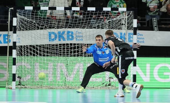 Oskar Joelsson scores a goal against goalkeeper Dejan Milosavljev duel Game scene Action Sport Handball DHB Pokal Round of 16 Men Season 2025 2026 06 11 2025 Füchse Berlin vs ThSV Eisenach