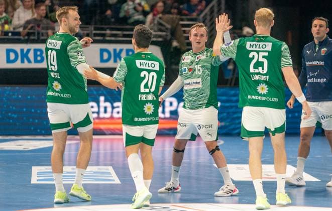 6 11 2025, Handball, Men, DHB Pokal 2025 26, Round of 16, Füchse Berlin ThSV Eisenach Mathias Gidsel Füchse Berlin, left, Tim Freihöfer Füchse Berlin, 2 from left, Tobias Grondahl Füchse Berlin, 3 from left and Matthes Langhoff Füchse Berlin, 2 from right cheering Berlin Max Schmeling Halle Brandenburg Germany