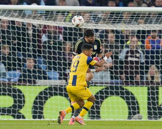 Birmingham, England, 6th November 2025. Emiliano Martinez of Aston Villa comes out and heads the ball clear under pressure from Elad Madmon of Maccabi Tel-Aviv during the Aston Villa vs Maccabi Tel-Aviv FC UEFA Europa League match at Villa Park, Birmingham. Picture credit should read: Andrew Yates Sportimage EDITORIAL USE ONLY. No use with unauthorised audio, video, data, fixture lists, club league logos or live services. Online in-match use limited to 120 images, no video emulation. No use in betting, games or single club league player publications. SPI_041_AY_Villa_Macabbi SPI-4269-0040