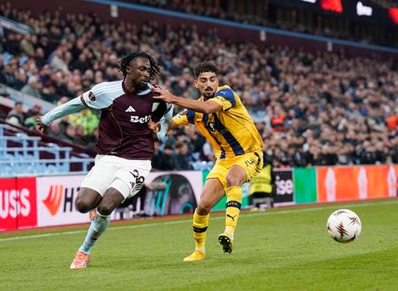 Birmingham, England, 6th November 2025. Evann Guessand of Aston Villa tackled by Roy Revivo of Maccabi Tel-Aviv during the Aston Villa vs Maccabi Tel-Aviv FC UEFA Europa League match at Villa Park, Birmingham. Picture credit should read: Andrew Yates Sportimage EDITORIAL USE ONLY. No use with unauthorised audio, video, data, fixture lists, club league logos or live services. Online in-match use limited to 120 images, no video emulation. No use in betting, games or single club league player publications. SPI_044_AY_Villa_Macabbi SPI-4269-0044