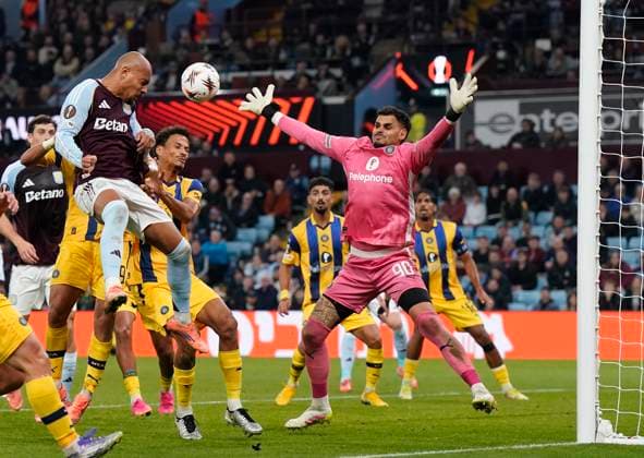 Birmingham, England, 6th November 2025. Donyell Malen of Aston Villa misses with a header as Roi Mishpati of Maccabi Tel-Aviv attempts to block during the Aston Villa vs Maccabi Tel-Aviv FC UEFA Europa League match at Villa Park, Birmingham. Picture credit should read: Andrew Yates Sportimage EDITORIAL USE ONLY. No use with unauthorised audio, video, data, fixture lists, club league logos or live services. Online in-match use limited to 120 images, no video emulation. No use in betting, games or single club league player publications. SPI_051_AY_Villa_Macabbi SPI-4269-0052