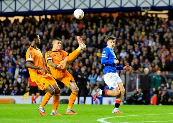 Rangers v A.S. Roma UEFA Europa League MatÃ¬as Soule of A.S. Roma (middle) clears under pressure from Mikey Moore of Rangers during the UEFA Europa League match at Ibrox Stadium, Glasgow UK Newspapers OUT Copyright: xFredxPalmerx FIL-22471-0038