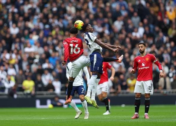8th November 2025; Tottenham Hotspur Stadium, London, England; Premier League Football, Tottenham Hotspur versus Manchester United, ManU Pape Matar Sarr of Tottenham Hotspur heads the ball above Amad Diallo of Manchester United  JohnxPatrickxFletcher