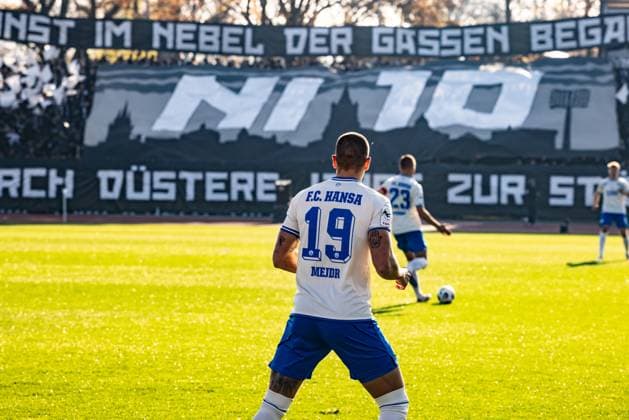 Football, Season 2025 2026, 3 Liga, Donaustadion Ulm, Matchday 14, SSV Ulm 1846 Football FC Hansa Rostock, 08 11 2025 08 11 2025, Football, Season 2025 2026, 3 Liga, Donaustadion Ulm, Matchday 14, SSV Ulm 1846 Football FC Hansa Rostock, 19 Jan Mejdr FC Hansa Rostock , in the background The fans of SSV Ulm in the D Block Donaustadion with a choreo for 15 years fan group Nebulosa Impero Photo Lucca Fundel Ulm Donaustadion Baden Württemberg Germany