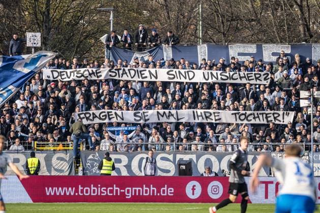 Football, Season 2025 2026, 3 Liga, Donaustadion Ulm, 14 Matchday, SSV Ulm 1846 Football FC Hansa Rostock, 08 11 2025 08 11 2025, Football, Season 2025 2026, 3 Liga, Donaustadion Ulm, 14 Matchday, SSV Ulm 1846 Football FC Hansa Rostock, Fanblock Gästeblock Fans FC Hansa Rostock Spruchband Deutsche Stadien sind Unsicher Ask your daughter Photo Lucca Fundel Ulm Donaustadion Baden Württemberg Germany
