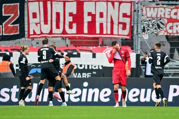 Essen player with goal celebration, jubilation, goal celebration, celebrate the goal, goal, celebration, jubilation over the goal to 0 2, optimistic, action, action, Jonas Scholz FC Ingolstadt, 15 looking disappointed, disappointment, frustration, disappointed, pessimistic, 08 11 2025, Ingolstadt Germany , Soccer, 3 Liga, FC Ingolstadt 04 Rot Weiss Essen, DFB DFL REGULATIONS PROHIBIT ANY USE OF PHOTOGRAPHS AS IMAGE SEQUENCES AND OR QUASI VIDEO xslx