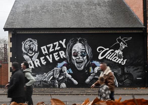 Birmingham, England, 9th November 2025. Fans pass the Ozzy Osbourne mural outside the ground ahead of the Aston Villa vs AFC Bournemouth Premier League match at Villa Park, Birmingham. Picture credit should read: Cody Froggatt Sportimage EDITORIAL USE ONLY. No use with unauthorised audio, video, data, fixture lists, club league logos or live services. Online in-match use limited to 120 images, no video emulation. No use in betting, games or single club league player publications. SPI_006_CF_ASTON_VILLA_V_BOURNEMOUTH SPI-4279-0006