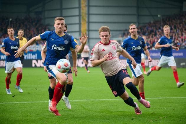 09 11 2025, Soccer, Men, 2 BL Bundesliga , Season 2025 2026, Holstein Kiel Fortuna Düsseldorf, Matchday 12 Carl Johansson in duel Christian Rasmussen Kiel Holstein Stadion Schleswig Holstein Germany