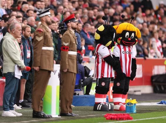 London, England, 9th November 2025. Brentford mascots pay their respects on Remembrance Day during the Brentford vs Newcastle United Premier League match at Gtech Community Stadium, London. Picture credit should read: David Klein Sportimage EDITORIAL USE ONLY. No use with unauthorised audio, video, data, fixture lists, club league logos or live services. Online in-match use limited to 120 images, no video emulation. No use in betting, games or single club league player publications. SPI_007_DK_Brentford_Newcastle SPI-4276-0008