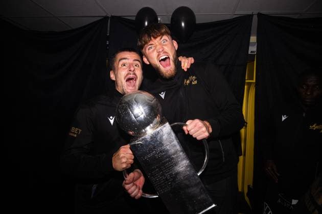 251109 Mjällbys Jesper Gustavsson and goalkeeper Noel Törnqvist cheer with Lennart Johanssons trophy after the football match in the Allsvenskan between Mjällby and Häcken on November 9, 2025 in Hällevik  Copyright: MATHILDAxSCHULER BB251109MA071
