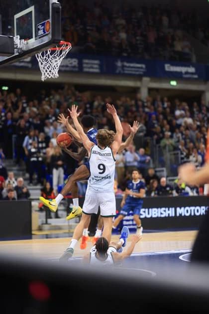 Marco Hollersbacher 9 Gladiators Trier tries the basket while Dominic Vengert 8 MLP Academics Heidelberg defends easyCredit BBL MLP Academics Heidelberg - Gladiators Trier 09 11 2025 at SNP Dome, Heidelberg Marco Hollersbacher 9 Gladiators Trier with a shot attempt Copyright: xspeedshotx