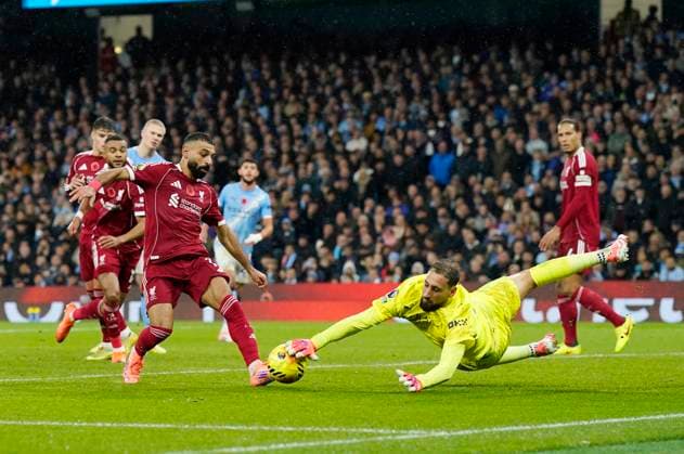 Manchester, England, 9th November 2025. Gianluigi Donnarumma of Manchester City saves at the feet of Mohamed Salah of Liverpool during the Manchester City vs Liverpool Premier League match at the Etihad Stadium, Manchester. Picture credit should read: Andrew Yates Sportimage EDITORIAL USE ONLY. No use with unauthorised audio, video, data, fixture lists, club league logos or live services. Online in-match use limited to 120 images, no video emulation. No use in betting, games or single club league player publications. SPI_075_AY_Man_City_Liverpool SPI-4280-0071