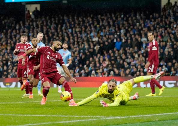 Manchester, England, 9th November 2025. Gianluigi Donnarumma of Manchester City saves at the feet of Mohamed Salah of Liverpool during the Manchester City vs Liverpool Premier League match at the Etihad Stadium, Manchester. Picture credit should read: Andrew Yates Sportimage EDITORIAL USE ONLY. No use with unauthorised audio, video, data, fixture lists, club league logos or live services. Online in-match use limited to 120 images, no video emulation. No use in betting, games or single club league player publications. SPI_076_AY_Man_City_Liverpool SPI-4280-0072